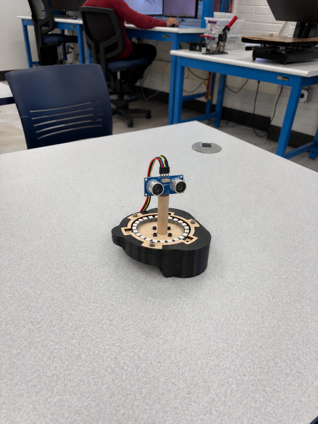 HC-SR04 ultrasonic sensor mounted on a wooden rotating riser above Michael’s custom sensor enclosure